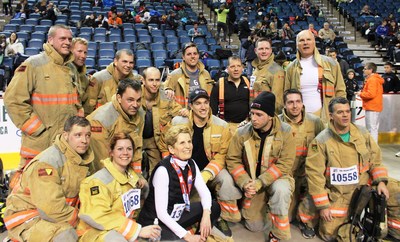 122nd Around the Bay Road Race in support of St. Joseph's Healthcare Foundation - Premier Kathleen Wynne with Hamilton Firefighters who raised over $5,700 for St. Joseph's Healthcare Hamilton and ran the 5K in their gear. (CNW Group/St. Joseph's Healthcare Foundation)