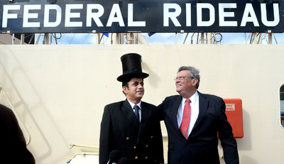 PortsToronto Harbour Master Angus Armstrong "crowns" Federal Rideau Captain Sharma Vinod Kumar with a 200-year-old silk and beaver top hat at the 155th annual Beaver Hat Ceremony at Redpath Refinery. (CNW Group/PortsToronto)