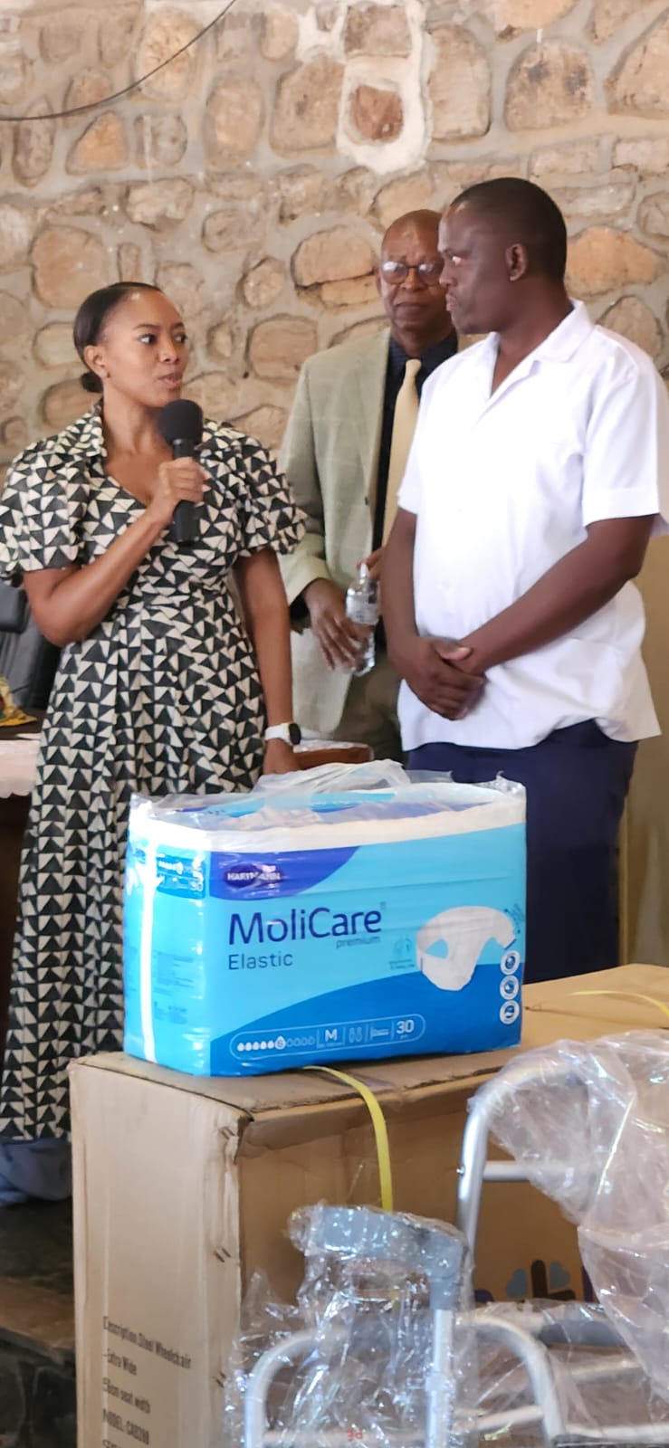 Country Manager Elisa Modikwa handing over equipment to one of the beneficiaries