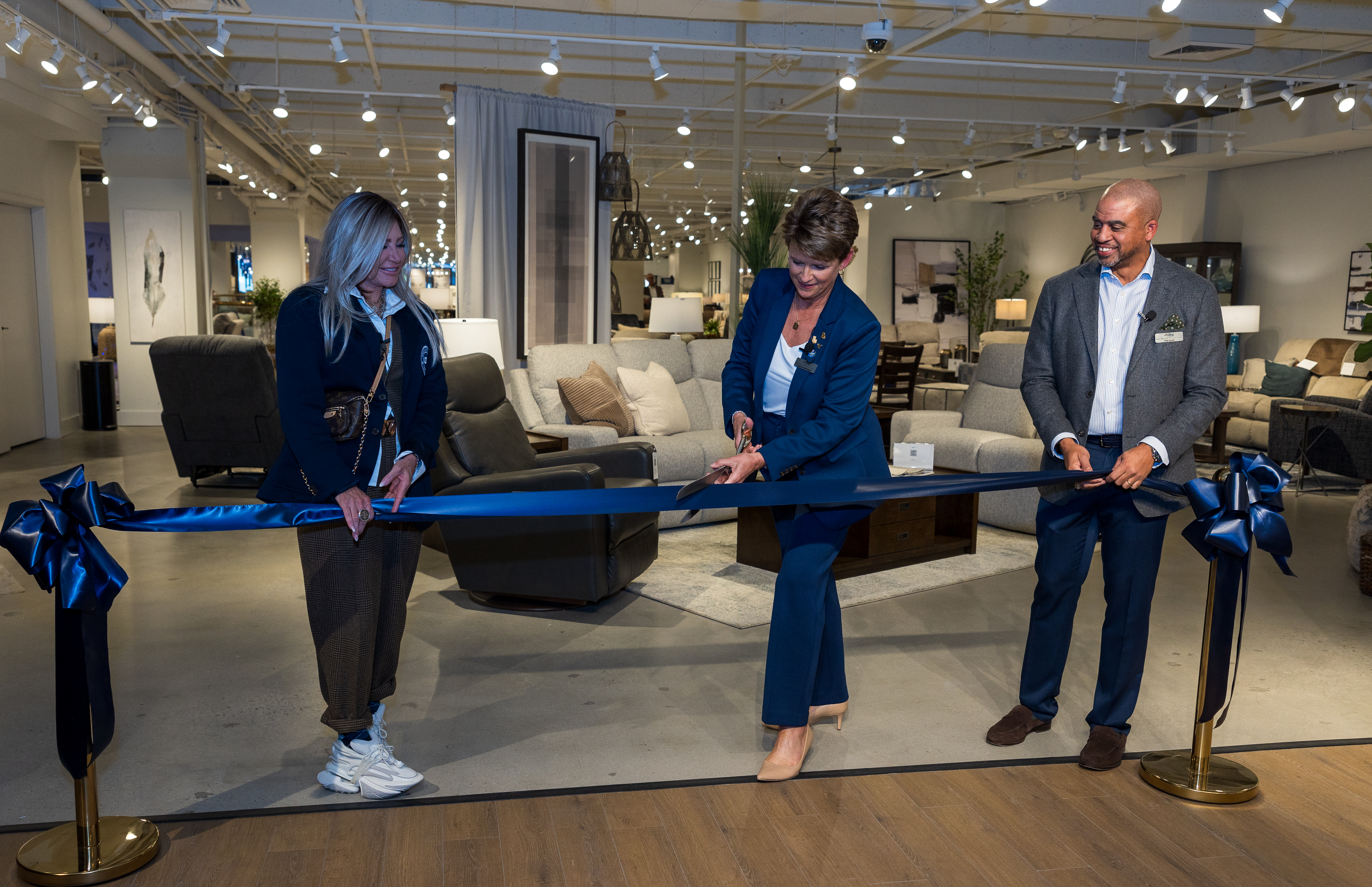 Melinda Whittington, Rob Sundy and Rebecca Reeder cut the ribbon to open the newly renovated La-Z-Boy Incorporated showroom at High Point Market